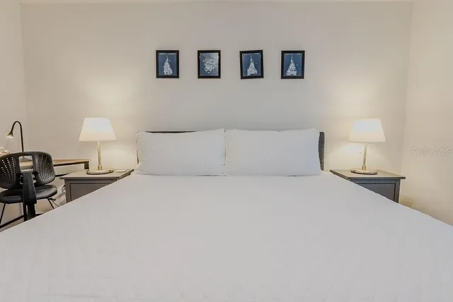 a bedroom with a bed and a chair