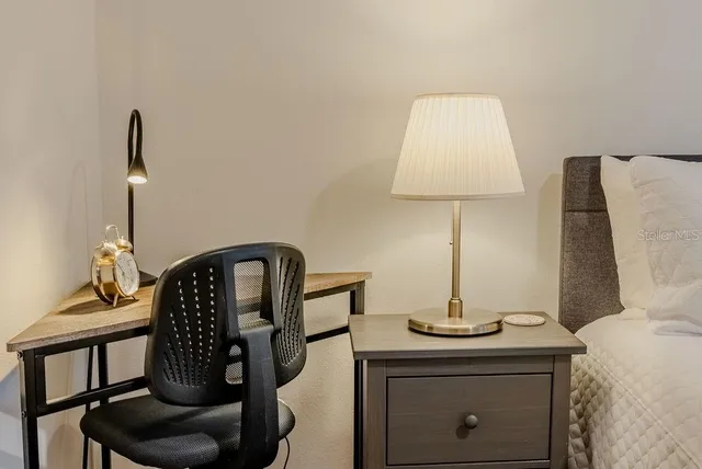 a large bed sitting in a bedroom and lamp