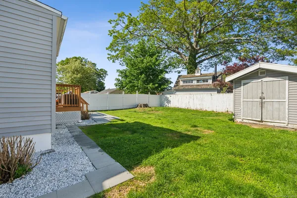 a view of a back yard of the house with green space