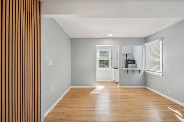a view of a kitchen with wooden floor and a refrigerator