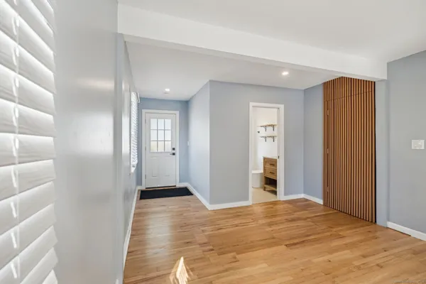 a view of empty room with wooden floor