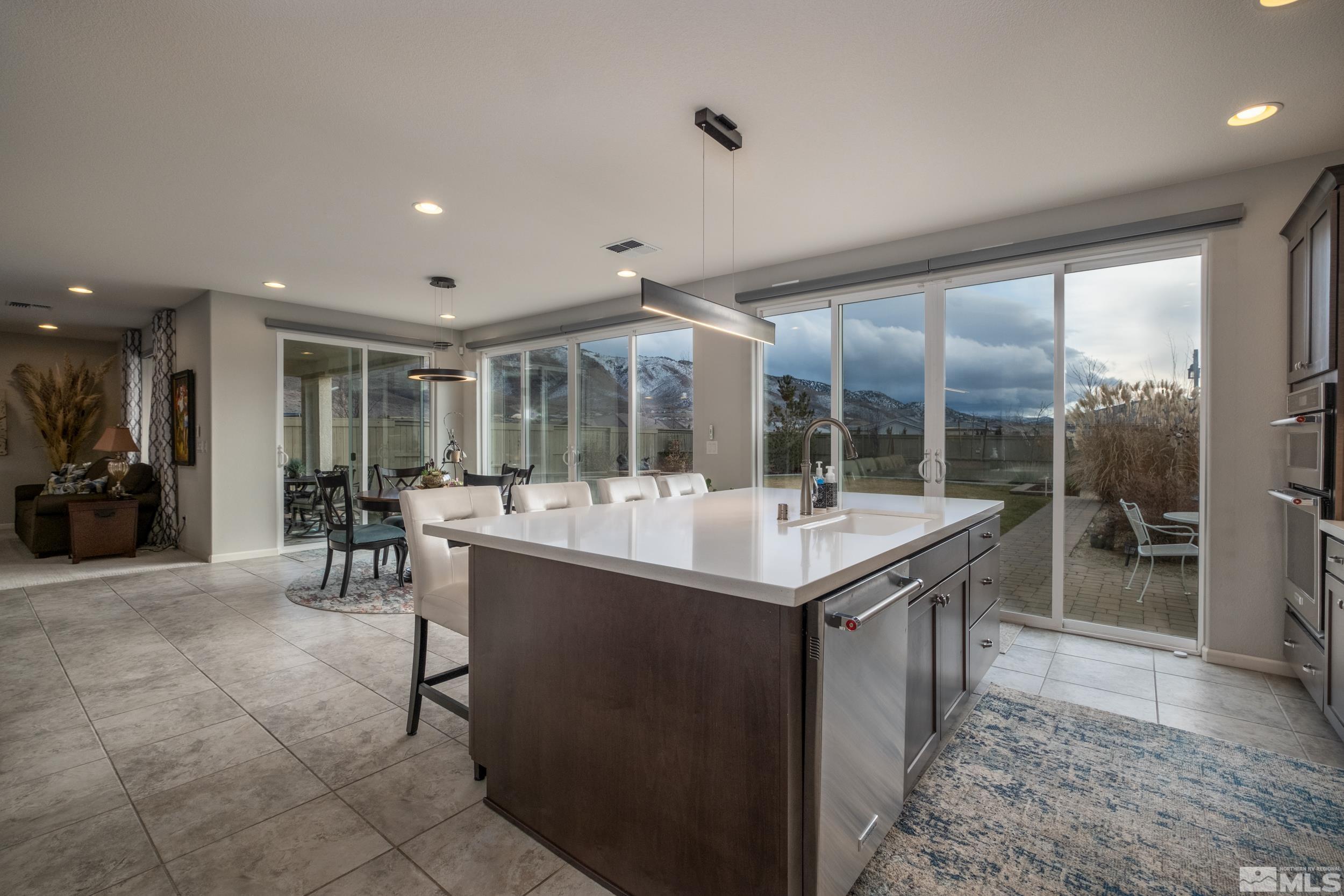 2960 Ethelinda Way Reno, NV 89521 - Photo 11 of 40 a dining hall with stainless steel appliances granite countertop a sink and cabinets
