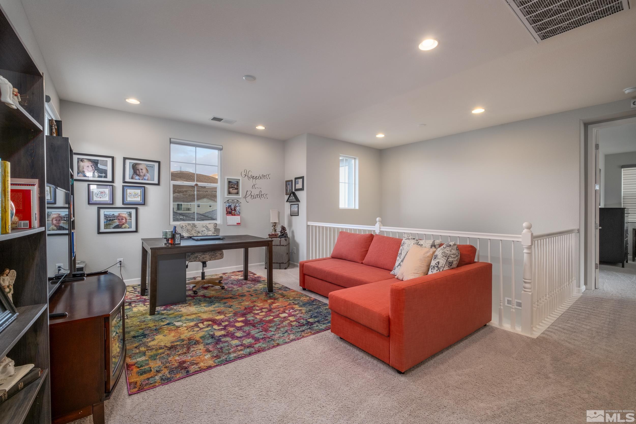2960 Ethelinda Way Reno, NV 89521 - Photo 18 of 40 a living room with furniture a rug and a bookshelf