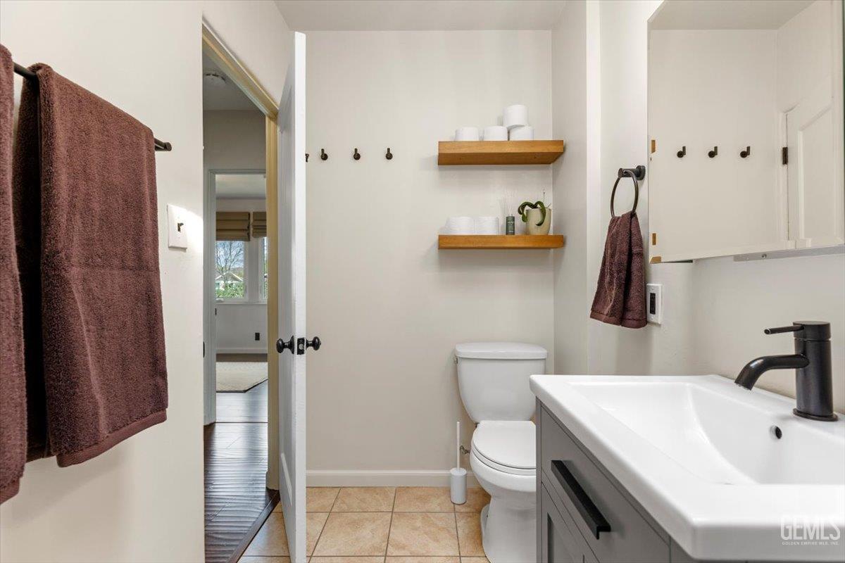 Undisclosed Address Tehachapi, CA 93561 - Photo 26 of 46 a bathroom with a sink a toilet and shower curtain