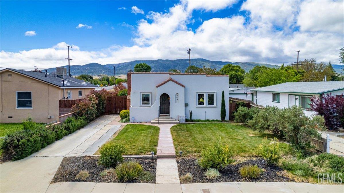 Undisclosed Address Tehachapi, CA 93561 - Photo 41 of 46 a view of a white house with a big yard plants and large tree