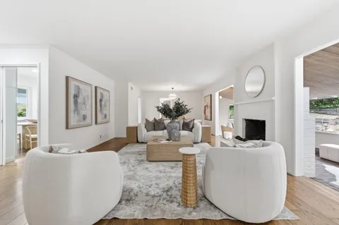 a living room with fireplace furniture and a fireplace