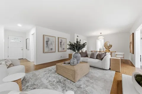 a living room with furniture and a large mirror