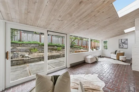 a living room with furniture and large windows