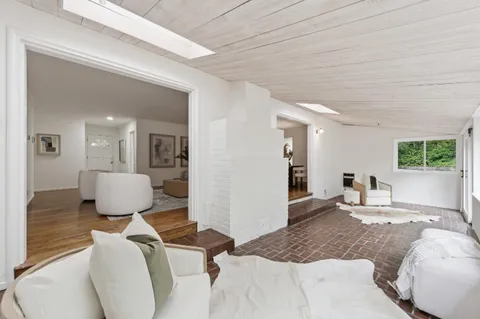 a living room with furniture window and wooden floor