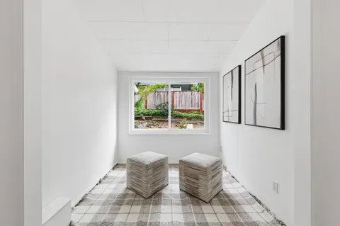 a view of wooden floor and windows in a room