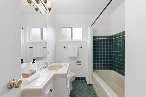 a bathroom with a sink a toilet and bathtub