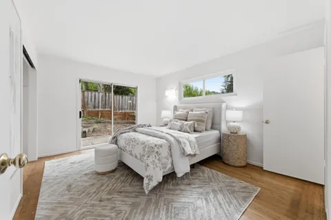 a bedroom with a bed and a couch