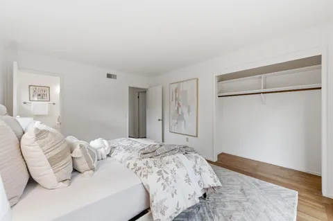 a bedroom with a bed and with wooden floor