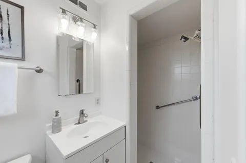 a bathroom with a sink and mirror