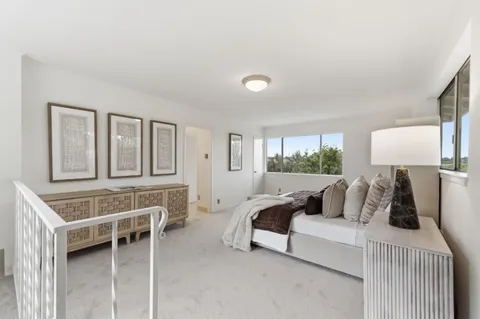 a bedroom with furniture and a window