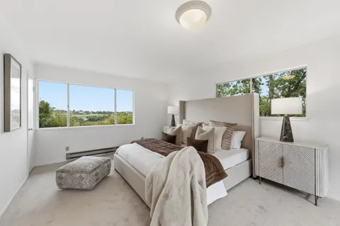 a bedroom with bed and window