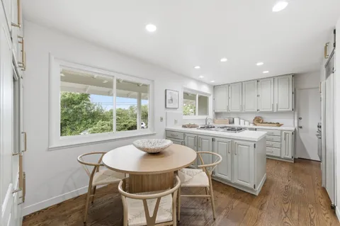a kitchen with a table and chairs in it