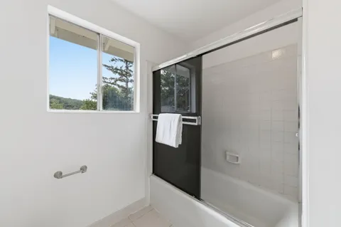 a bathroom with a bathtub and a shower