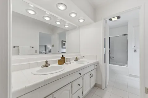a bathroom with a sink double vanity and a mirror