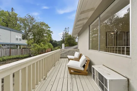 a view of balcony with furniture