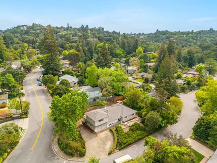 an aerial view of a house with lots of trees