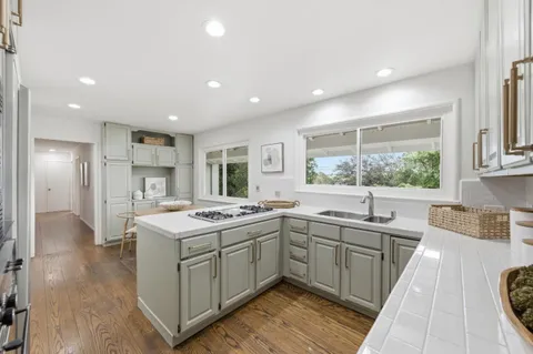 a kitchen with a sink stove and cabinets