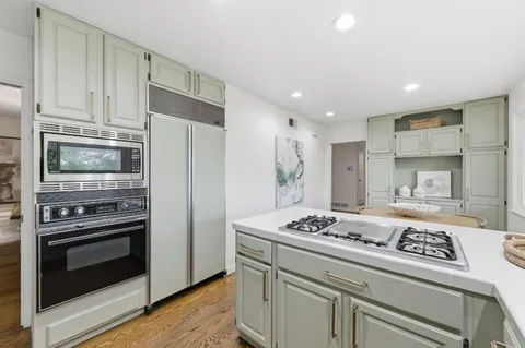 a kitchen with a stove and a refrigerator