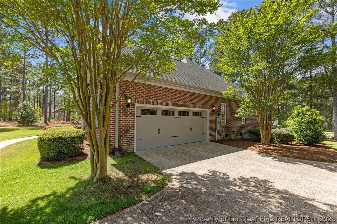 30180 East Lake Road Wagram, NC 28396 - Photo 40 of 42 a front view of a house with a yard garage and outdoor seating