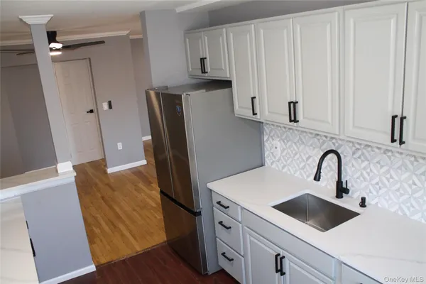 a kitchen with stainless steel appliances a refrigerator sink and cabinets