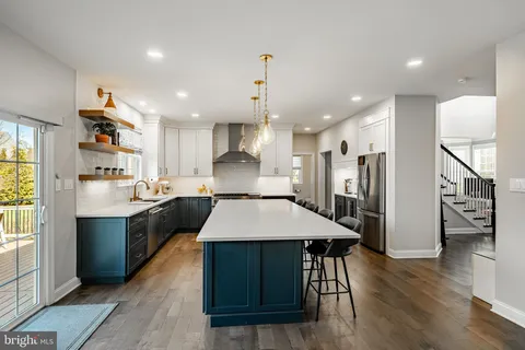 a kitchen with a stove a sink a refrigerator and a cabinets