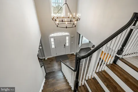 a view of a hallway with wooden floor and entryway