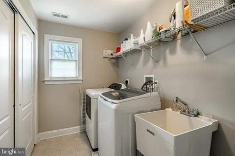 a walk in closet with clothes