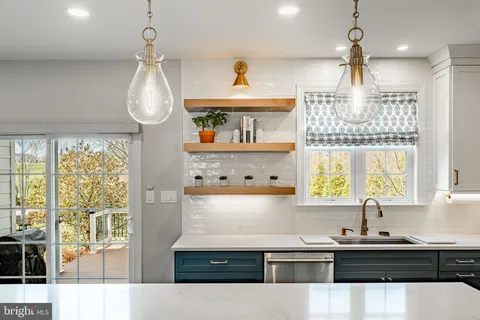 a kitchen with stainless steel appliances granite countertop a stove refrigerator and wooden floor