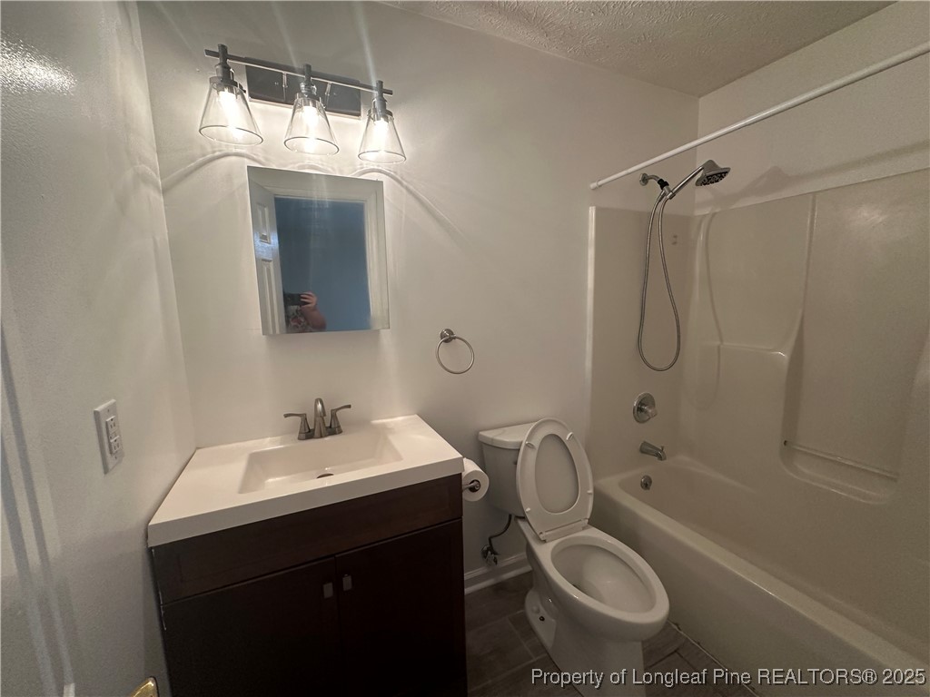 8249 Rockfish Road Raeford, NC 28376 - Photo 11 of 12 a bathroom with a sink toilet and shower