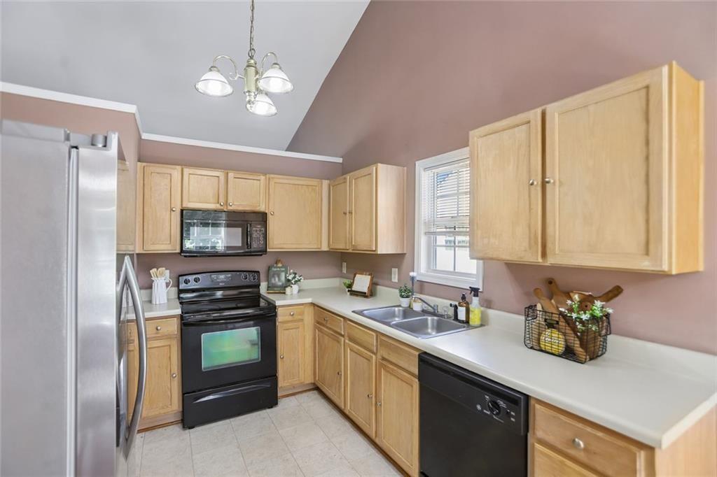 9720 Poole Road Villa Rica, GA 30180 - Photo 3 of 40 a kitchen with a sink a counter cabinets and appliances