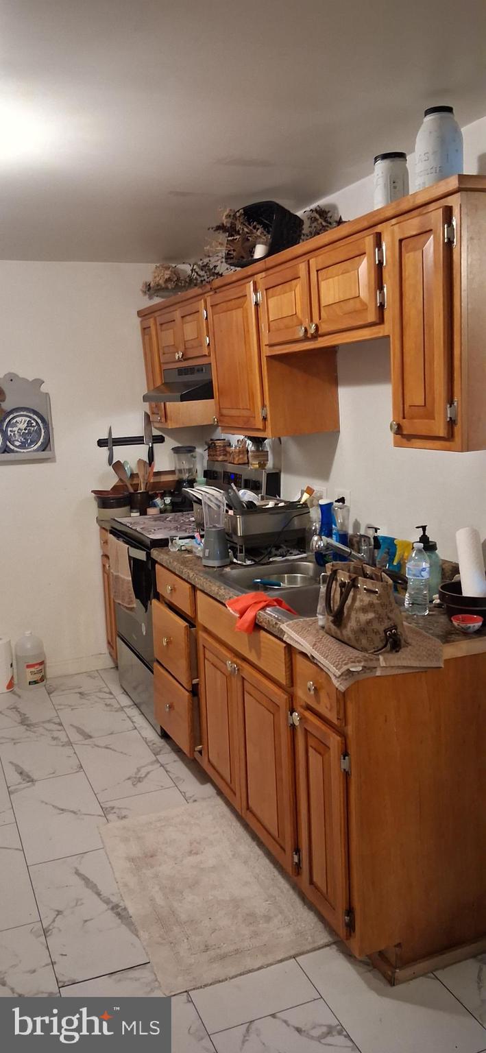 327-329 West Main Street Everett, PA 15537 - Photo 20 of 81 a kitchen with stainless steel appliances granite countertop a stove a sink and a microwave