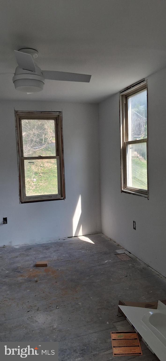 327-329 West Main Street Everett, PA 15537 - Photo 63 of 81 an empty room with wooden floor cabinet and windows