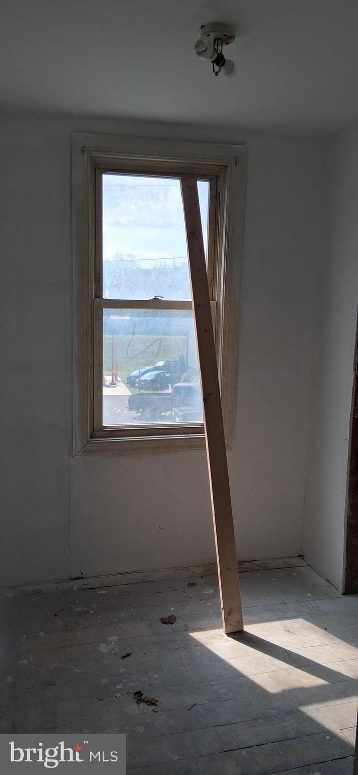 327-329 West Main Street Everett, PA 15537 - Photo 64 of 81 an empty room with wooden floor and windows