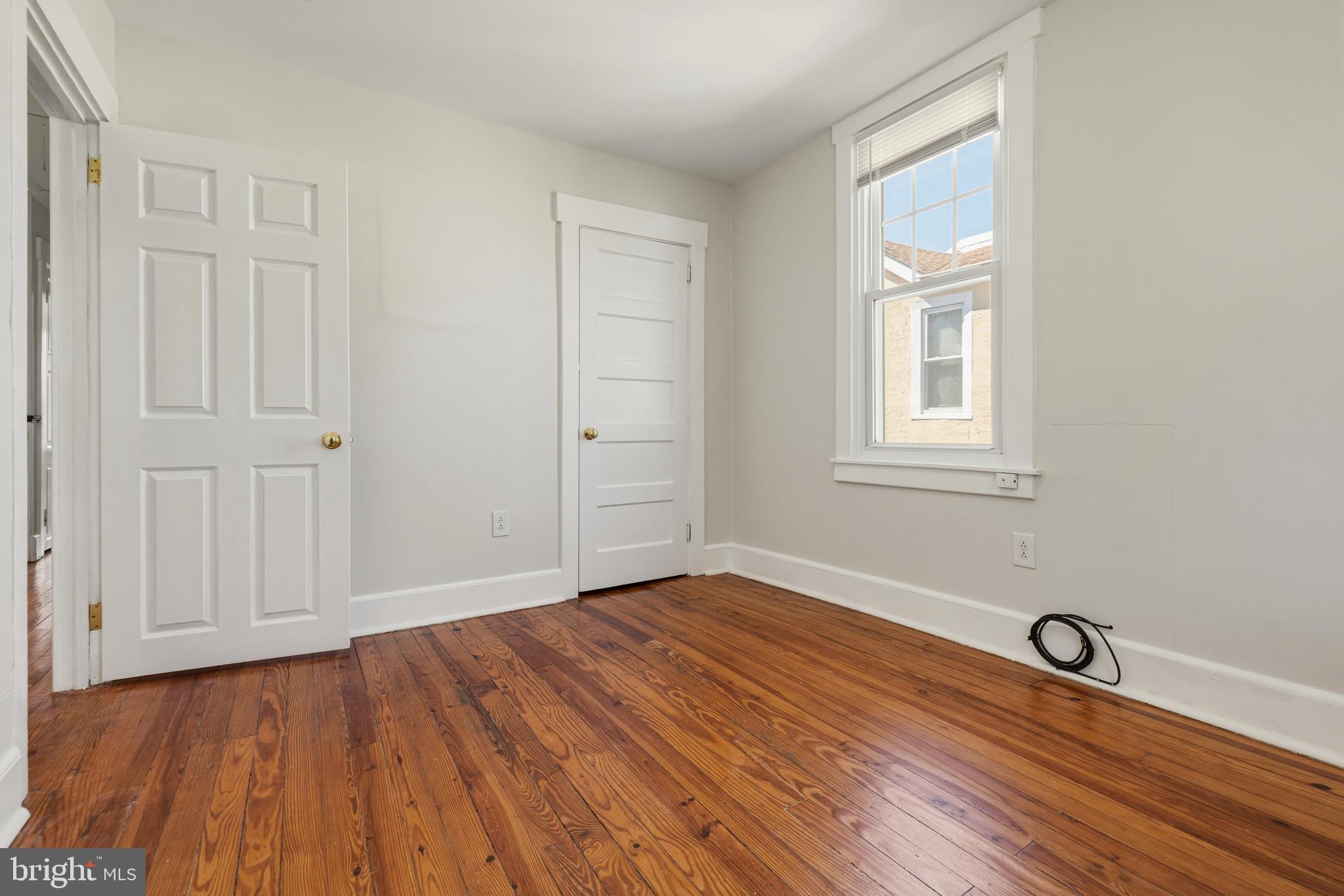 229 Wayne Avenue Narberth, PA 19072 - Photo 28 of 35 an empty room with wooden floor and windows