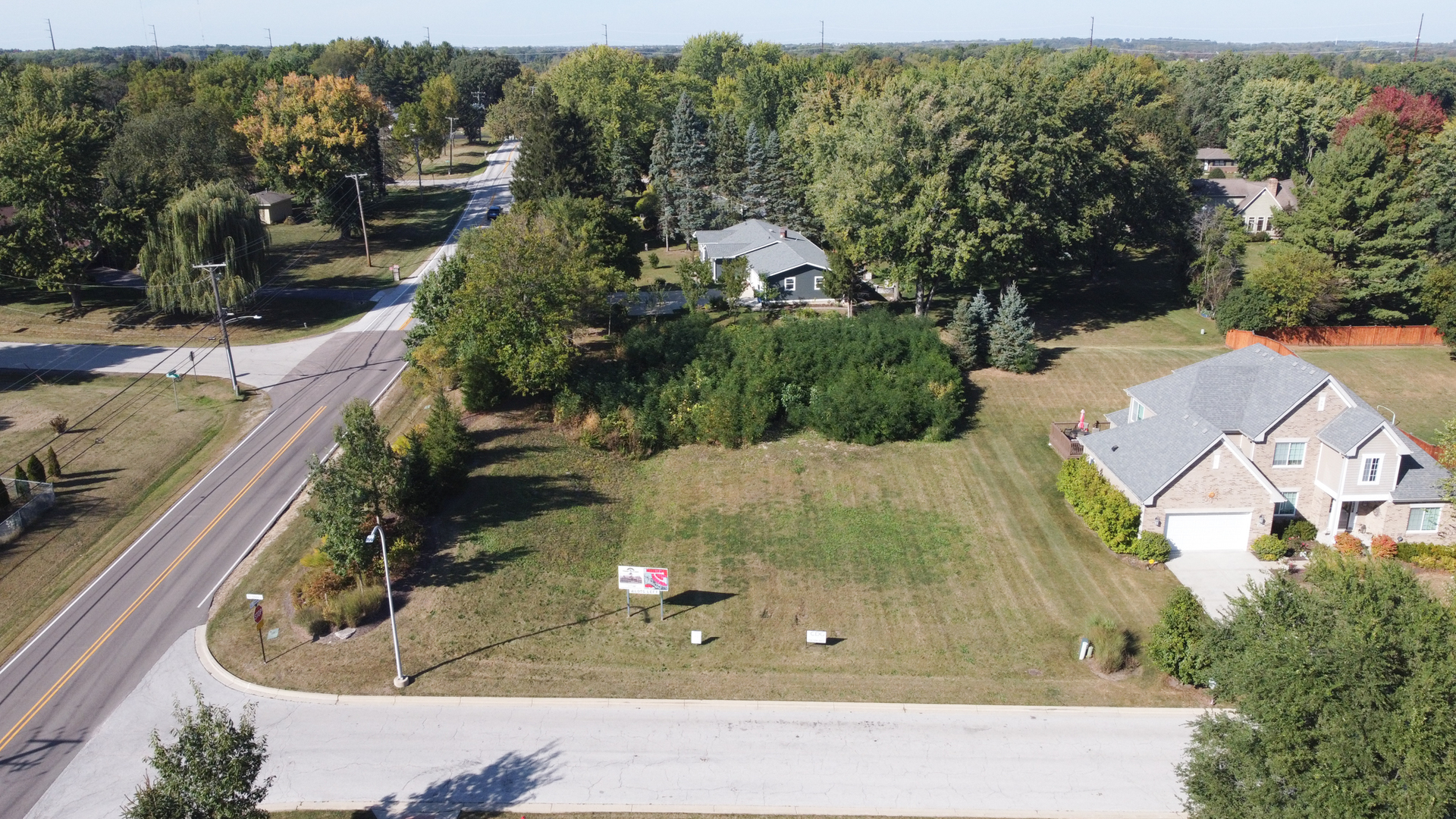 an aerial view of residential houses with outdoor space