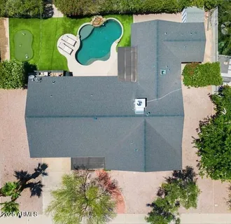 an aerial view of a house with a yard