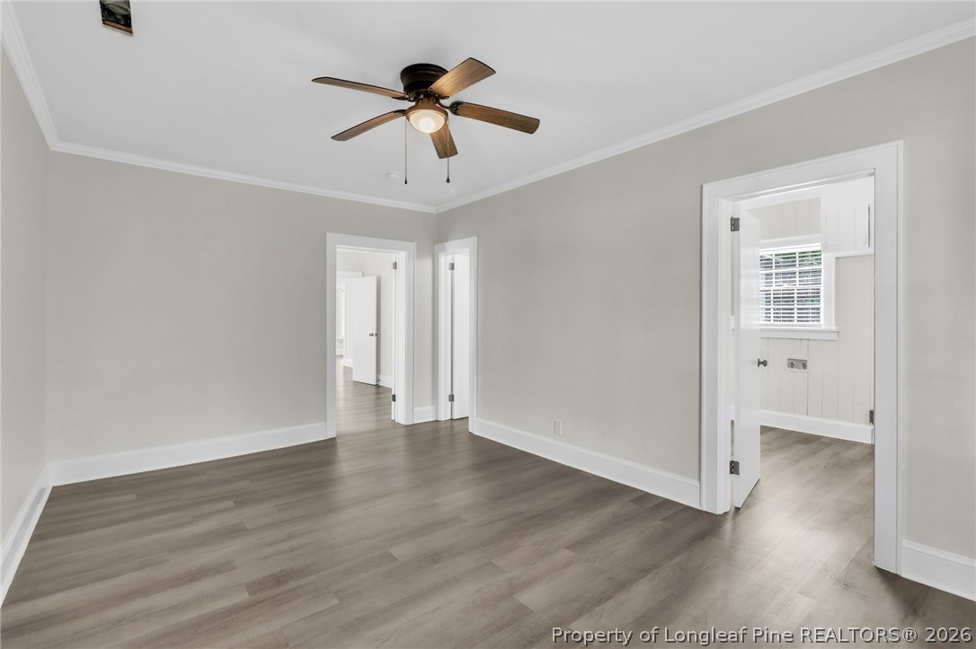 203 Trinity Street Fairmont, NC 28340 - Photo 25 of 34 a view of an empty room with wooden floor and a ceiling fan