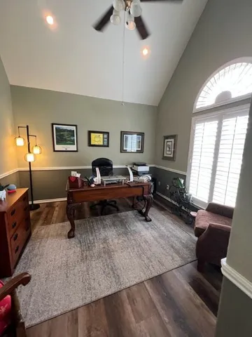 a living room with furniture piano and a window