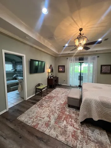 a bedroom with furniture and a flat screen tv