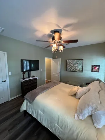 a bedroom with a bed and a chandelier