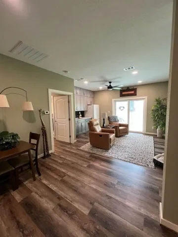 a living room with furniture and a wooden floor