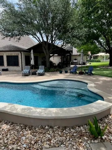 a front view of a house with a yard and a garden