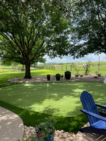 a view of a garden with lawn chairs and swimming pool