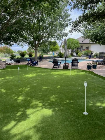 a view of a house with a swimming pool and sitting area