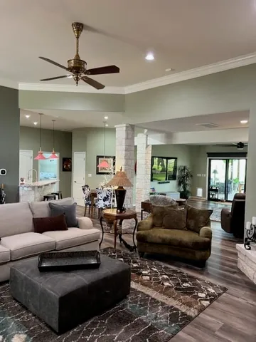 a living room with furniture ceiling fan and a rug